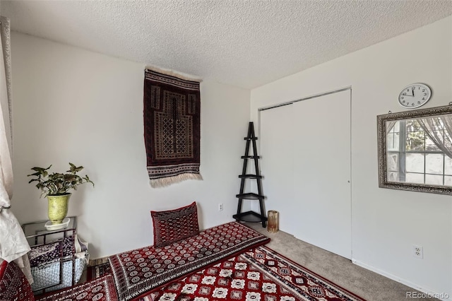 carpeted bedroom featuring a textured ceiling