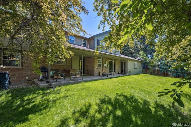 5755 S Fulton Way, Greenwood Village, CO 80111 - rear view of house featuring a lawn, brick siding, and a patio