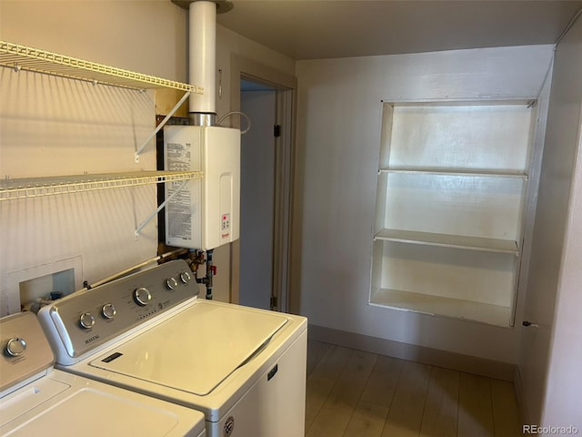 laundry area featuring washer and dryer, hardwood / wood-style flooring, and water heater