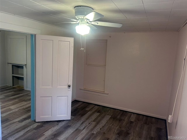 unfurnished bedroom featuring dark hardwood / wood-style floors and ceiling fan