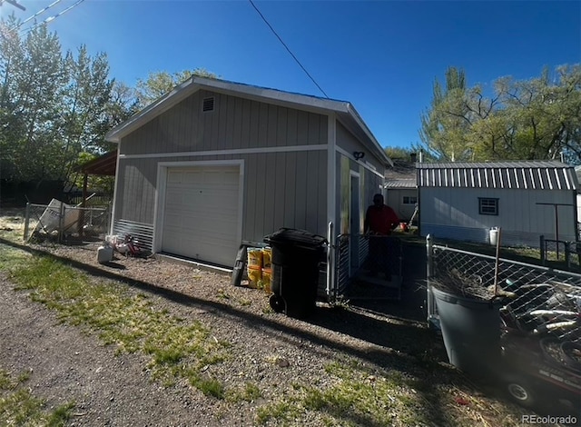 view of side of home with an outbuilding and a garage