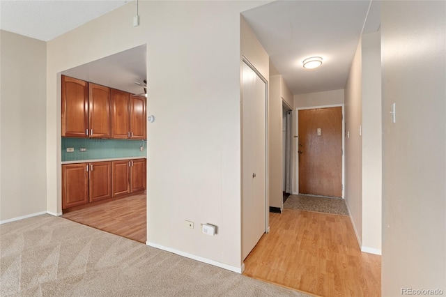 hallway with light colored carpet