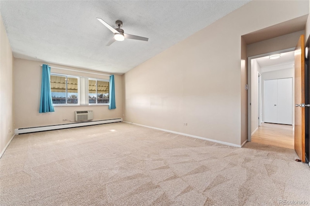 carpeted empty room with ceiling fan, a textured ceiling, a wall mounted AC, and a baseboard heating unit