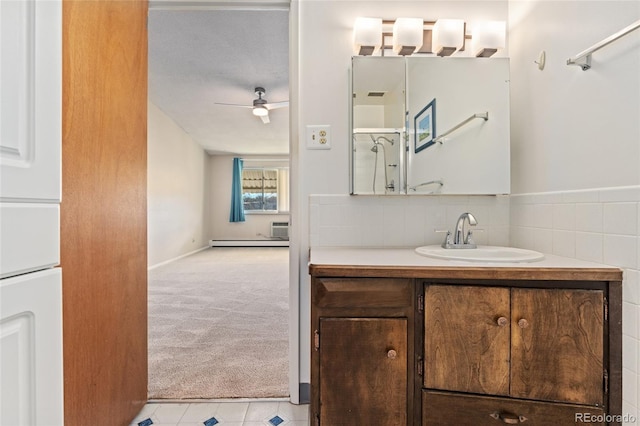 bathroom featuring walk in shower, vanity, baseboard heating, and ceiling fan