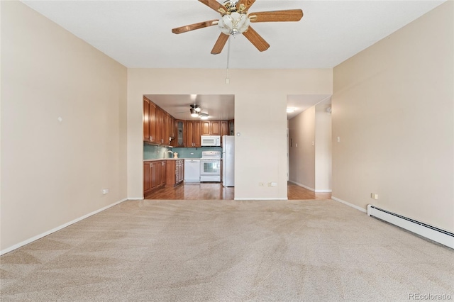 unfurnished living room with carpet flooring, ceiling fan, sink, and a baseboard radiator