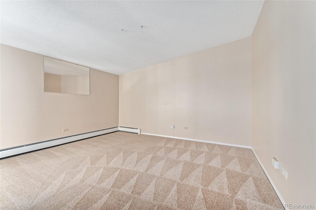 carpeted spare room with a textured ceiling and a baseboard heating unit