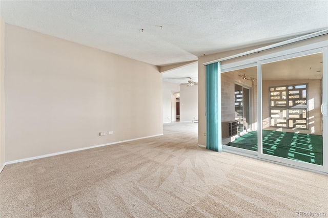 carpeted spare room with a textured ceiling, ceiling fan, and lofted ceiling