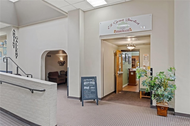 interior space featuring carpet floors and a paneled ceiling