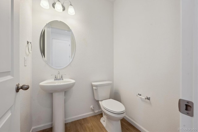 1331 Rock Cliff Ave, Erie, CO 80516 - half bath with toilet, wood finished floors, baseboards, and a sink