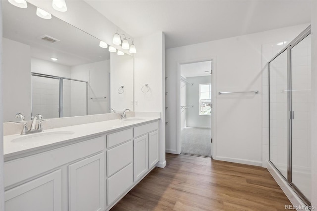 1331 Rock Cliff Ave, Erie, CO 80516 - bathroom with a shower stall, double vanity, a sink, and wood finished floors