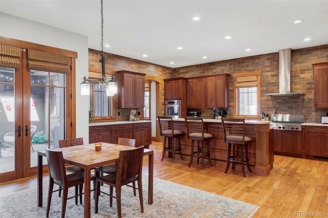 1143 S Saint Paul St, Denver, CO 80210 - dining space with light wood-type flooring, recessed lighting, french doors, and arched walkways