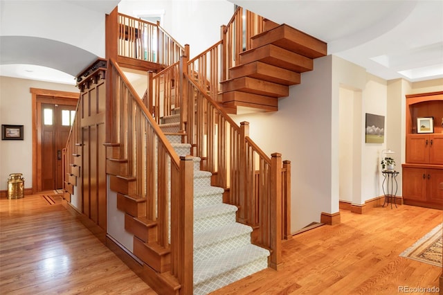 1143 S Saint Paul St, Denver, CO 80210 - stairs featuring arched walkways, wood finished floors, and baseboards