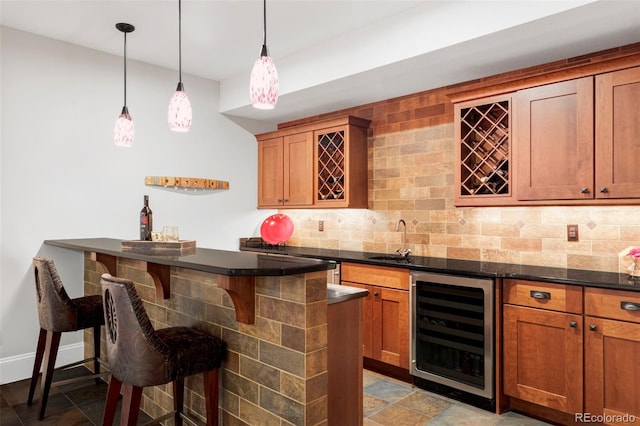 1143 S Saint Paul St, Denver, CO 80210 - indoor wet bar featuring wine cooler, decorative backsplash, decorative light fixtures, and stone finish flooring