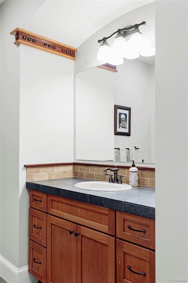1143 S Saint Paul St, Denver, CO 80210 - bathroom featuring vanity, backsplash, and baseboards