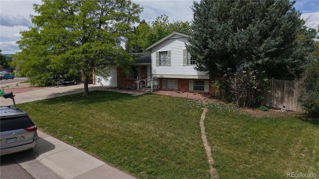 6437 W Arbor Dr, Littleton, CO 80123 - tri-level home with driveway, a garage, and brick siding