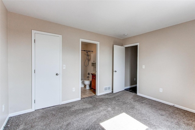 unfurnished bedroom featuring carpet, connected bathroom, visible vents, and baseboards