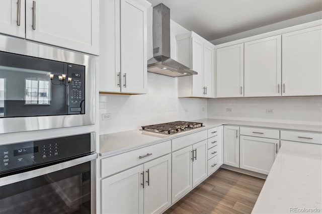 39161 Anthony St, Elizabeth, CO 80107 - kitchen with wall chimney exhaust hood, stainless steel appliances, light countertops, and white cabinets