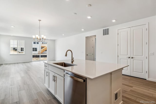 39161 Anthony St, Elizabeth, CO 80107 - kitchen with dishwasher, a sink, light wood-style flooring, a center island with sink, and open floor plan