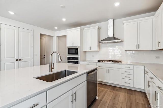 39161 Anthony St, Elizabeth, CO 80107 - kitchen with a sink, wall chimney range hood, stainless steel appliances, light wood-style floors, and white cabinetry