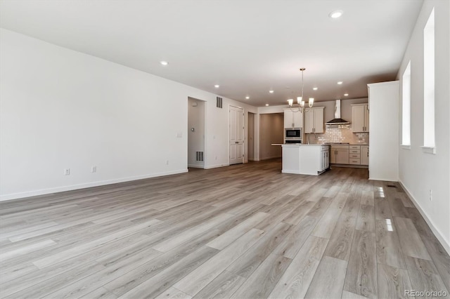 39161 Anthony St, Elizabeth, CO 80107 - unfurnished living room featuring a chandelier, recessed lighting, light wood-style flooring, and baseboards