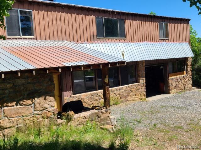 2703 Dave Wood Rd, Montrose, CO 81403 - view of front of house with stone siding and a metal roof