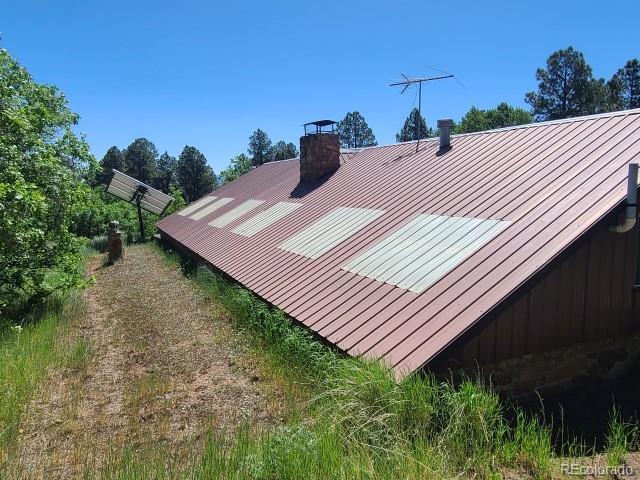 2703 Dave Wood Rd, Montrose, CO 81403 - exterior view of a metal roof and a chimney
