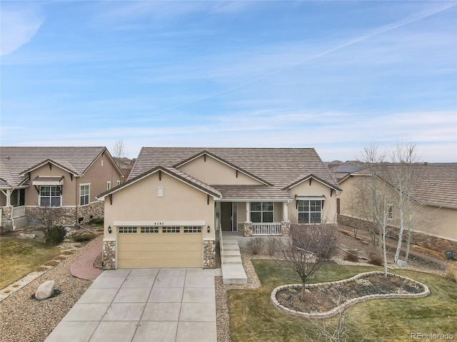 single story home with a porch, a garage, and a front lawn