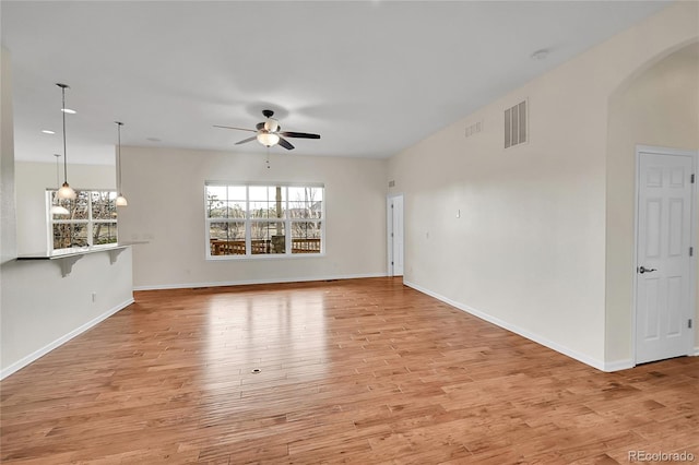 unfurnished living room featuring ceiling fan and light hardwood / wood-style floors