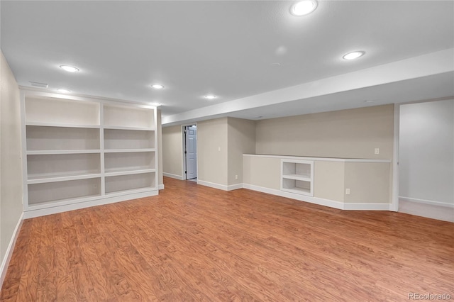 basement with hardwood / wood-style floors