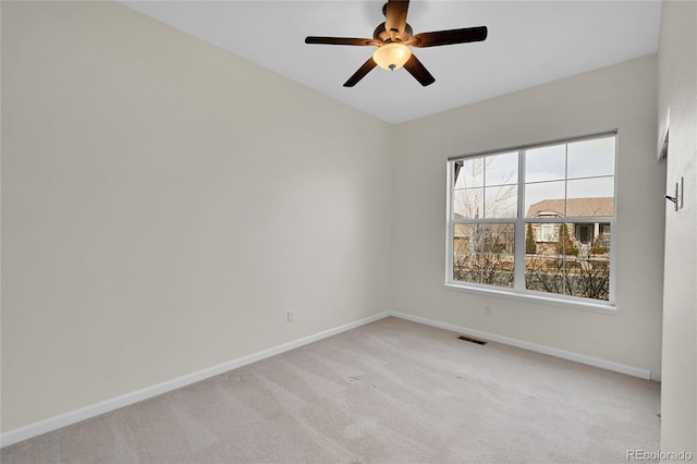 carpeted empty room featuring ceiling fan