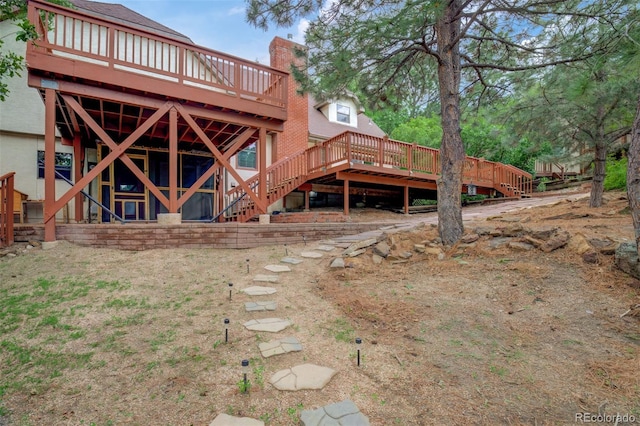969 Pulpit Rock Ct, Colorado Springs, CO 80918 - back of property featuring stairs, a wooden deck, and a chimney