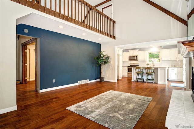969 Pulpit Rock Ct, Colorado Springs, CO 80918 - living room with a high ceiling, baseboards, dark wood-type flooring, and recessed lighting