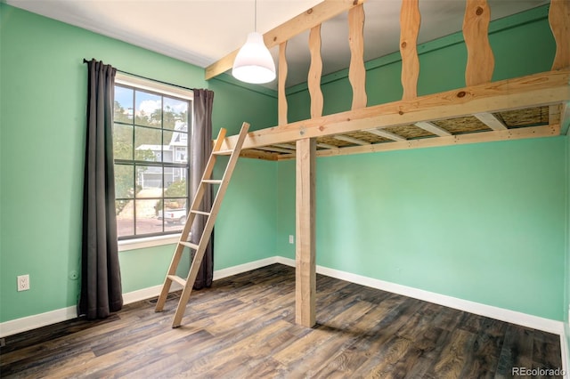 969 Pulpit Rock Ct, Colorado Springs, CO 80918 - unfurnished bedroom featuring multiple windows, baseboards, and dark wood-style floors