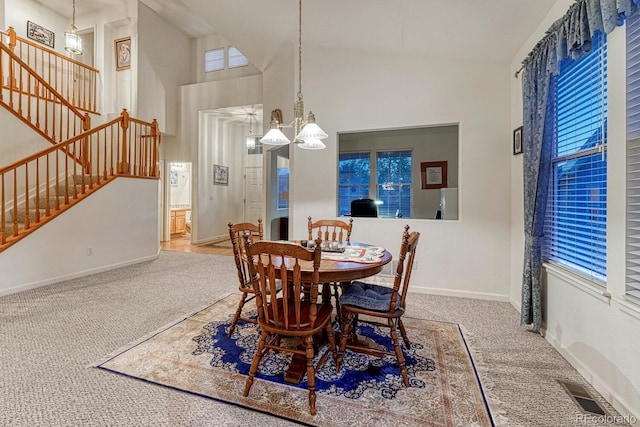 dining room with stairs, carpet flooring, visible vents, and a healthy amount of sunlight