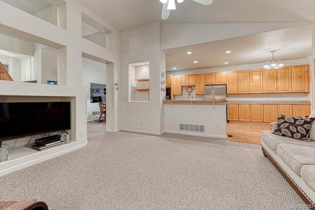 living area featuring light colored carpet, visible vents, recessed lighting, and ceiling fan with notable chandelier