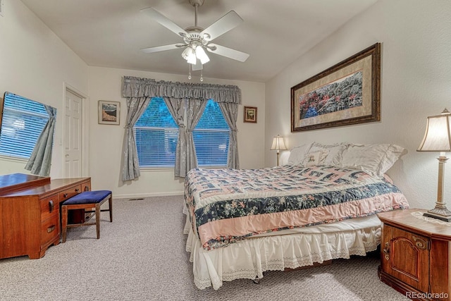 bedroom with a ceiling fan, baseboards, visible vents, and carpet