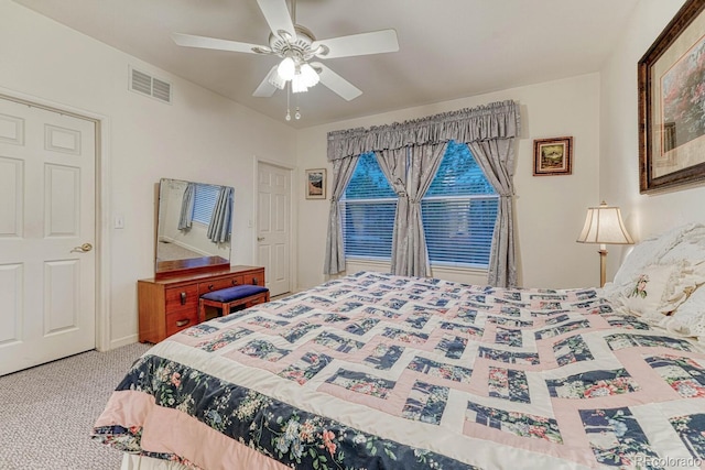 carpeted bedroom with a ceiling fan and visible vents