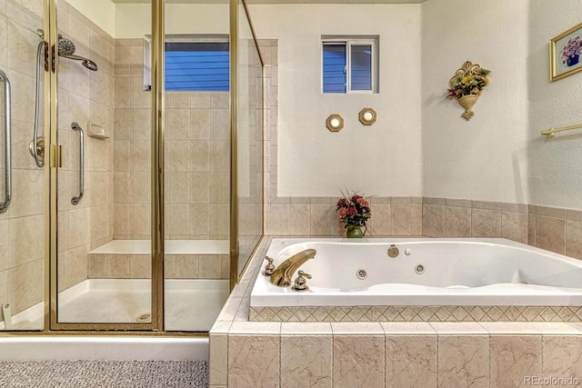 bathroom with a whirlpool tub and a shower stall
