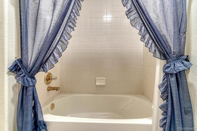 bathroom with shower / bath combination with curtain