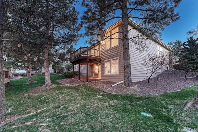 view of home's exterior with a wooden deck and a yard