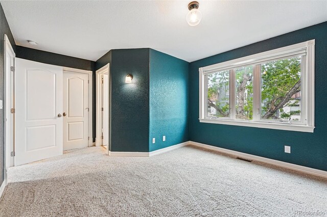 2319 Decatur St, Denver, CO 80211 - carpeted spare room featuring a smoke detector and a textured wall