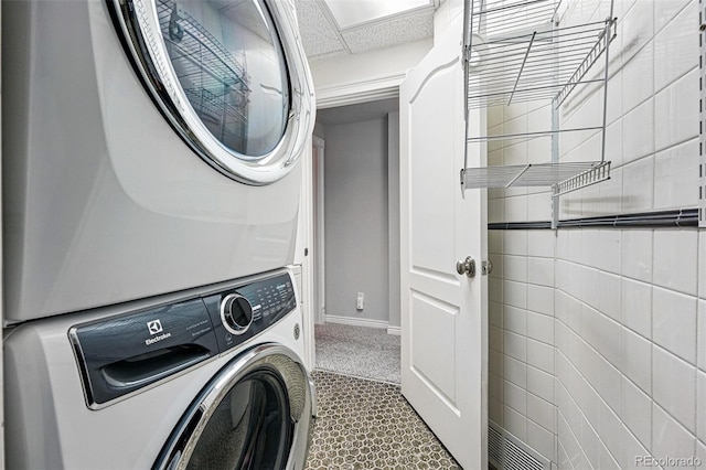 2319 Decatur St, Denver, CO 80211 - washroom with stacked washer / dryer and carpet flooring