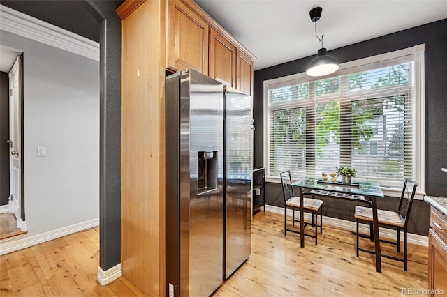2319 Decatur St, Denver, CO 80211 - kitchen featuring stainless steel refrigerator with ice dispenser, light wood-type flooring, brown cabinetry, ornamental molding, and hanging light fixtures