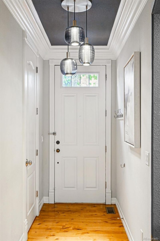 2319 Decatur St, Denver, CO 80211 - foyer featuring crown molding, light wood-type flooring, and a tray ceiling