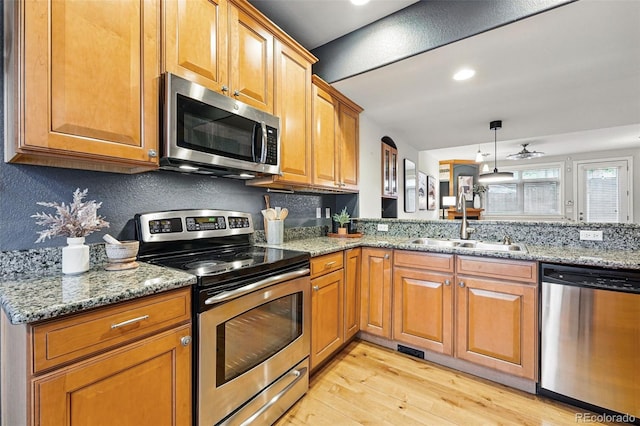 2319 Decatur St, Denver, CO 80211 - kitchen with stainless steel appliances, light wood finished floors, light stone countertops, and recessed lighting