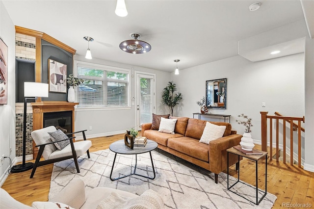 2319 Decatur St, Denver, CO 80211 - living area with light wood-style floors and a glass covered fireplace