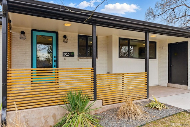 1920 S Niagara St, Denver, CO 80224 - doorway to property featuring brick siding and a porch
