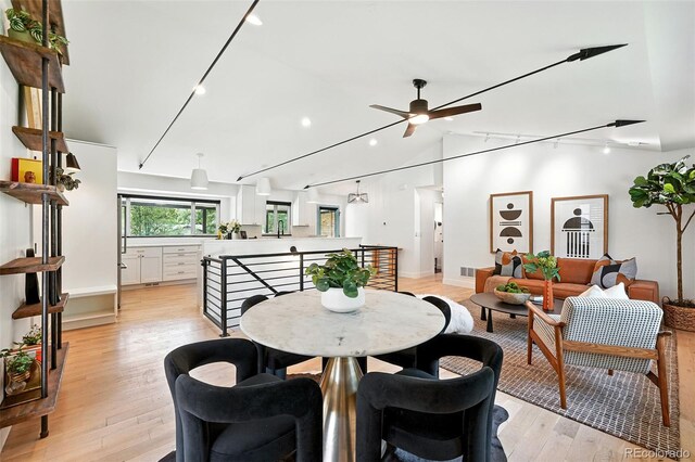 1920 S Niagara St, Denver, CO 80224 - dining room featuring rail lighting, ceiling fan, recessed lighting, light wood-style flooring, and lofted ceiling