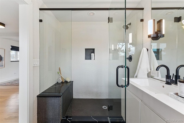 1920 S Niagara St, Denver, CO 80224 - bathroom featuring vanity, a shower stall, and wood finished floors
