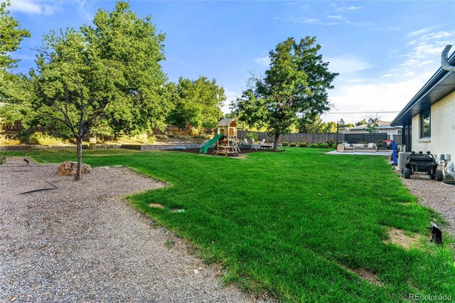 1920 S Niagara St, Denver, CO 80224 - fenced backyard featuring a playground and a patio